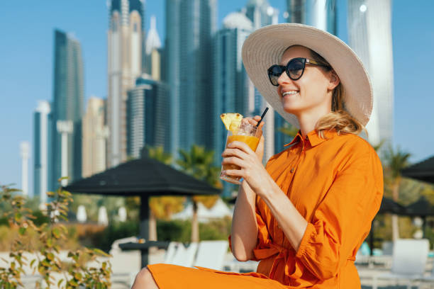 woman enjoying vacations at Dubai marina beach resort stock photo