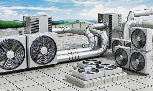 Commercial HVAC units on the rooftop of a building. Air conditioner units connected with steel pipes.