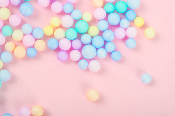 Colorful polystyrene foam on pink background, creativity concepts