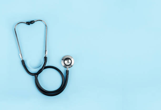istock The stethoscope, black, blue background, isolated 1466366512
