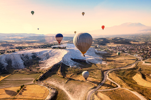 Vacation in Turkey showing hot air balloon flying across Pamukkale in Hierapolis