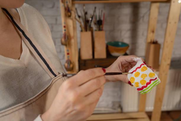 istock Female hands painting a pottery 1466366651