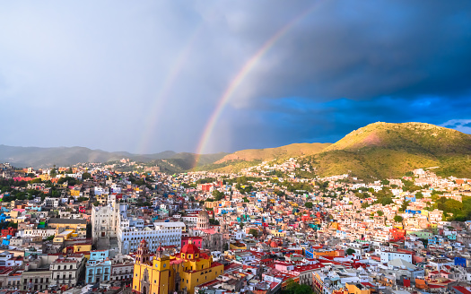 double rainbows with colourful urban buildings as the foreground after the rain at sunset