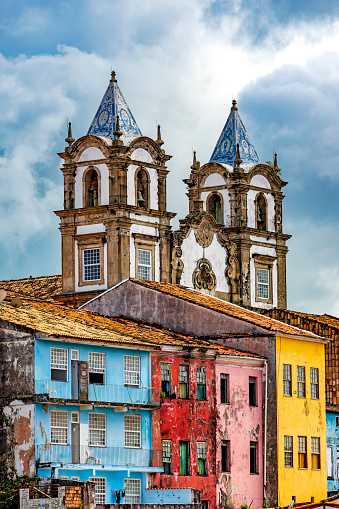 Historic baroque church towers rising between old colorful houses in the Pelourinho district in the city of Salvador, Bahia