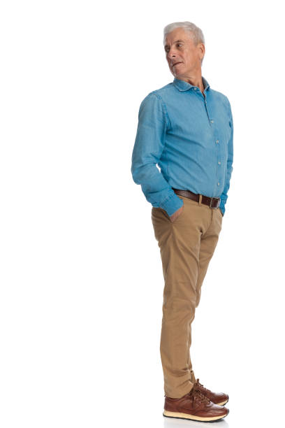 istock old man with grey hair looking over shoulder and posing with hands in pockets 1466372941