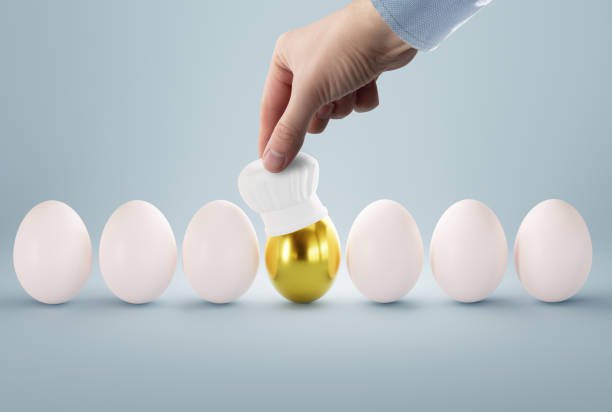 istock The hand puts a cook hat on the egg. 1466374104