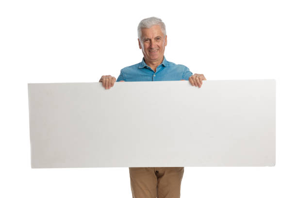 istock proud grandpa holding and presenting board while smiling 1466374127