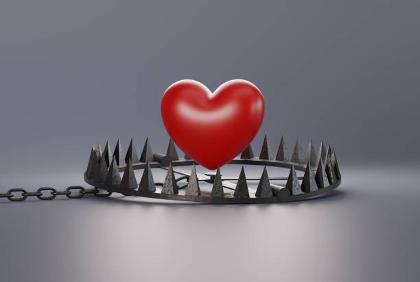 istock Heart over a snare, a trap on a dark background. 1466374594