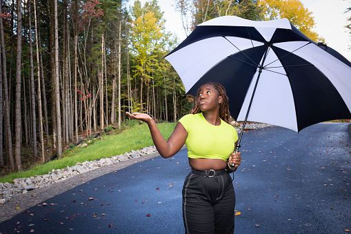 Portrait of woman holding large umbrella