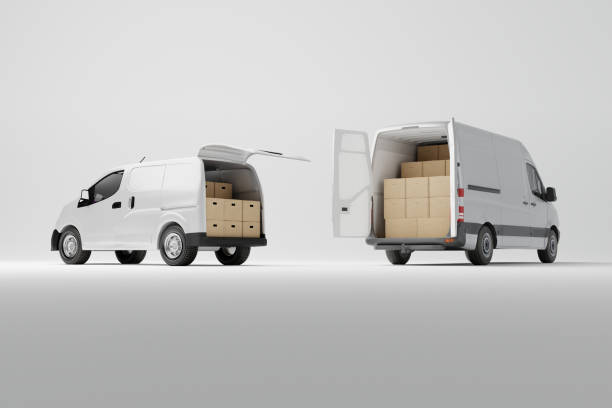 istock Two commercial delivery white vans with cardboard boxes on white background. 1466375930