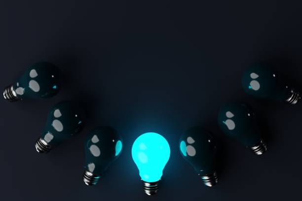 istock One lit blue light bulb in the background of other non-luminous light bulbs, dark background. 1466377933