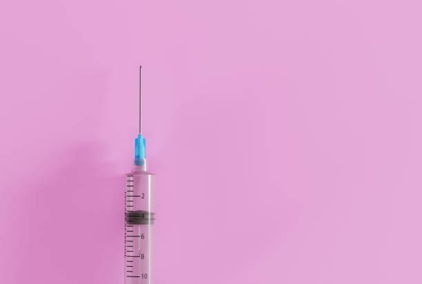istock Syringe for making injections on a dark background. 1466380340