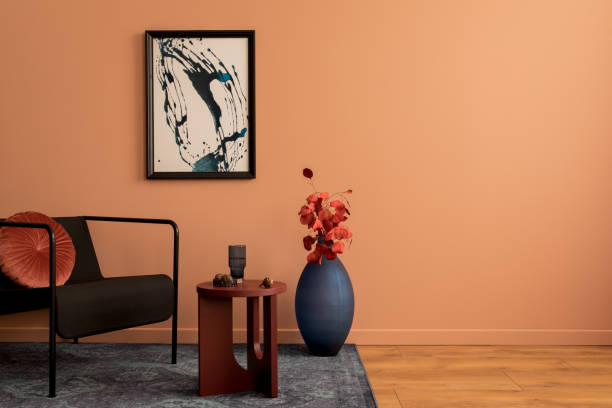 istock Creative composition of living room interior with mock up poster frame, copy space, navy vase with dried flowers, black armchair, round coffee table and personal accessories. Home decor. Template. 1466380607