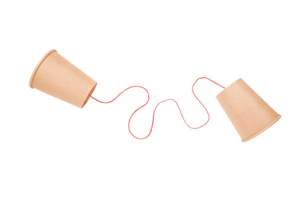 istock Old style cup phone with red string isolated on white background 1466380998