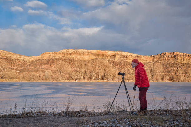 istock senior male photographer with a camera on tripod 1466381197