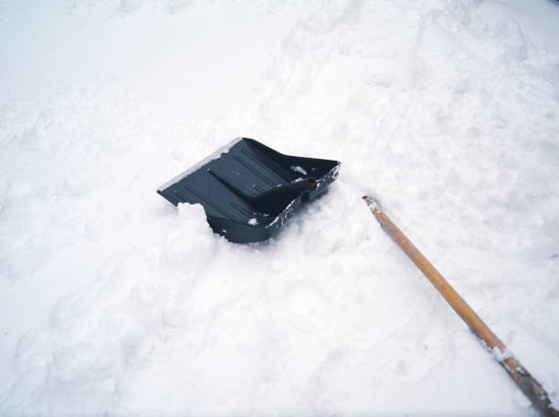 a snow shovel abandoned on the snow with broken handle, winter scene