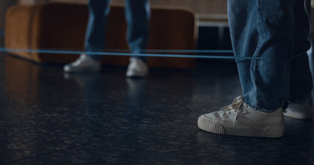 istock Closeup legs children playing rubber band game. Unknown joyful pupils jumping. 1466383436