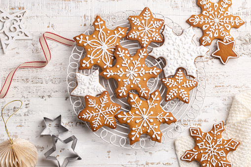 Homemade gingerbread snowflakes icing cookies. Christmas and New Year baking or decoration idea, festive holiday sweet food concept. Close up, white background, top view