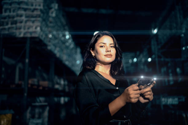 Portrait of a young woman analyzing graphs on digital intelligence in a warehouse Portrait of a young woman analyzing graphs on digital intelligence in a warehouse digital transformation factory stock pictures, royalty-free photos & images