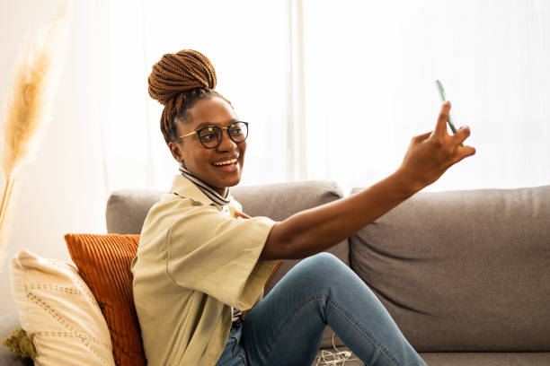 istock Smiling African American woman taking selfie 1466388947