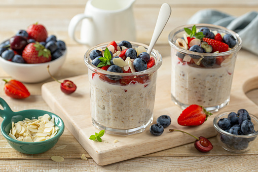 Overnight oats with fresh berries in glass jar, healthy breakfast