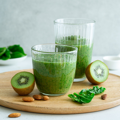 Fresh green smoothie with kiwi and spinach. Healthy food concept, selective focus, square image