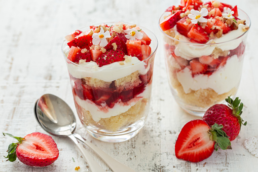 strawberry vanilla cream dessert in glasses, white background