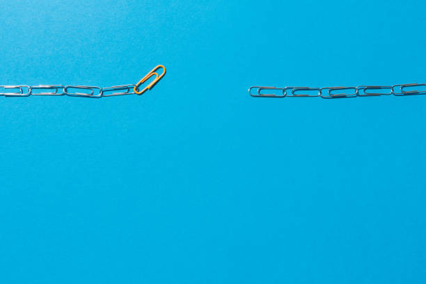 istock Chains formed by clips in which an orange link serves as a link. 1466390254