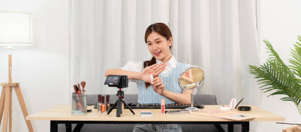 istock Young beauty influencer showing lipstick product to testing and recommend cosmetic while recording video 1466392400