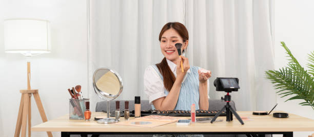 istock Young beauty influencer is using brush to applying blush on on cheek to testing and recommend cosmetic 1466392409