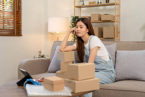 istock Young entrepreneur is feeling disappointed and bored after checking online order while sitting on the couch 1466392567