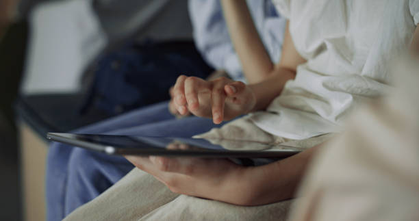 istock Child hand tapping tablet computer at break close up. Pupils surfing internet. 1466392702