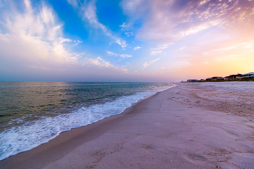 A colorful sunset on Pensacola Beach with gentle waves