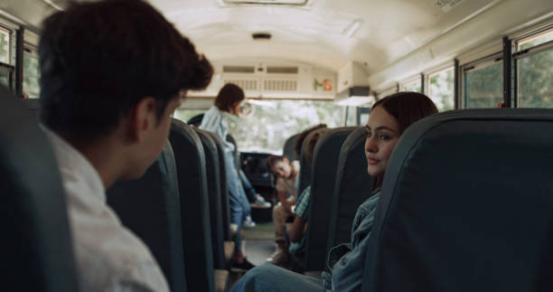 istock Multiethnic classmates chatting ride school bus. Kids wait schoolmates to board. 1466395772