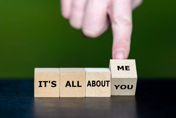 istock Hand turns dice and changes the expression 'it's all about you' to 'it's all about me'. 1466396128