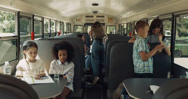 istock Pupils sitting school bus waiting trip. Children using gadgets on way home 1466396768