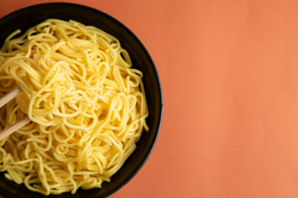 istock yellow noodle in a black bowl 1466405667