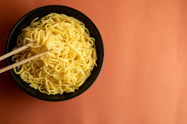 istock yellow noodle in a black bowl 1466405913