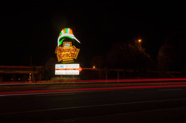The famous Pensacola Beach sign lit at night with neon tubes prior to being replaced for repairs in 2019