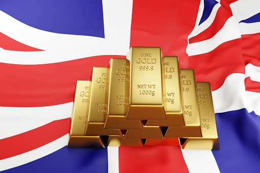 Piles of bullion on UK national flag, Union Jack. Illustration of the concept of gold reserve of British central bank