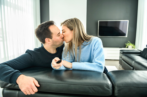 A Portrait of caucasian couple sit relax on comfortable sofa in modern house