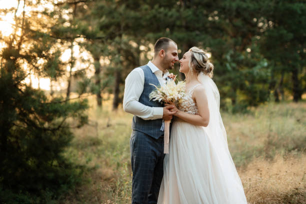 istock the groom and the bride are walking in the forest 1466412074