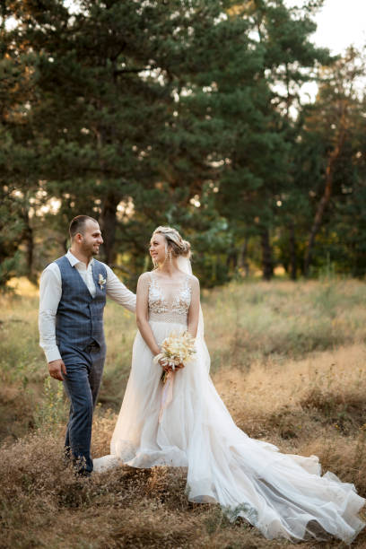 istock the groom and the bride are walking in the forest 1466414934