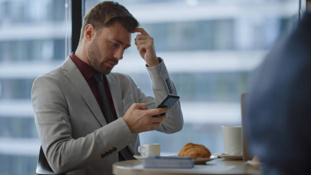 istock Serious entrepreneur sitting cafe using mobile phone surfing internet in office. 1466416981