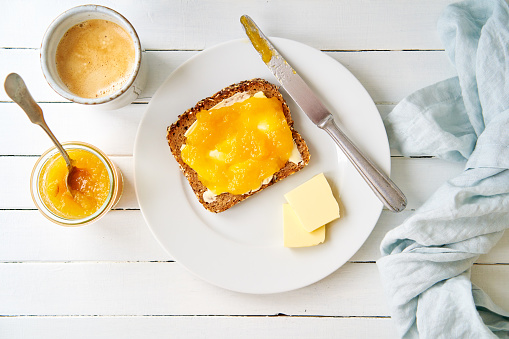 Breakfast table with a slice of bread and marmalade