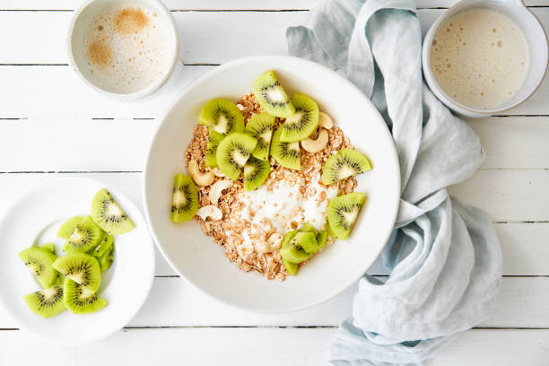 Spelt muesli with sliced kiwi, curd cheese and oat drink