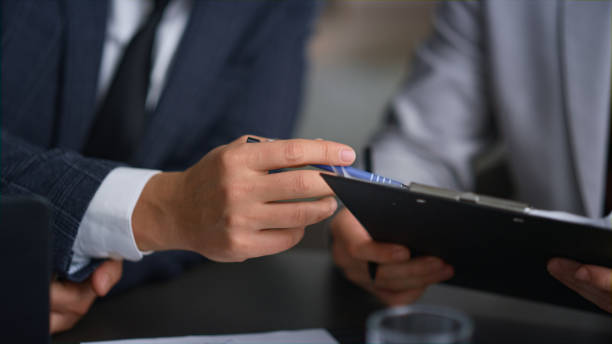 istock Businessman hands writing document analysing corporate report in company office. 1466419701