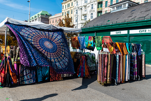 Vienna, Austria - October 17, 2022: Clothing store with colored handkerchiefs in Naschmarkt, street market in Vienna, Austria