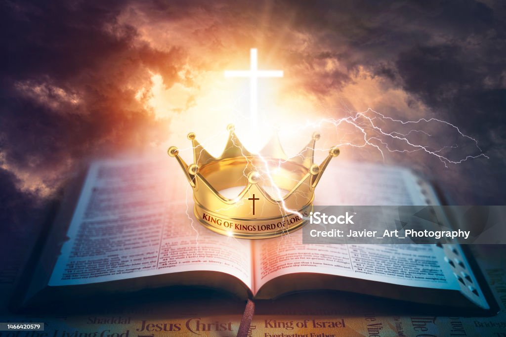 King of Kings Lord of lords powerful scene. Gold crown on top of the Holy Bible illuminated by a glowing cross and the sun. Powerful image of the glory of God. Jesus Christ Stock Photo
