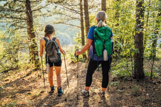 istock Mother and daughter hikers exploring woods 1466423287